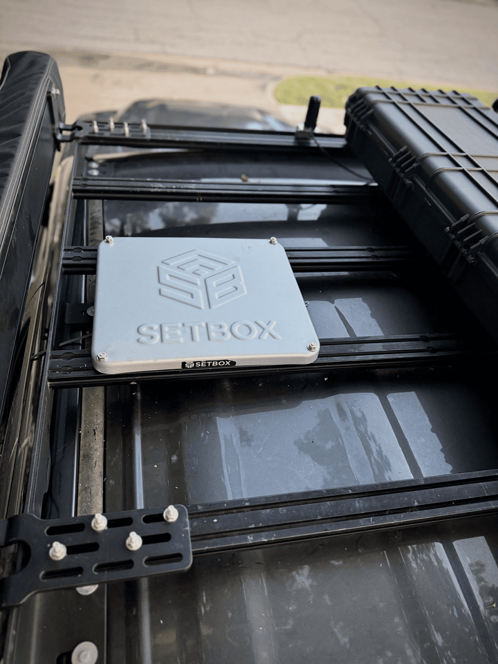 SETBOX housing sitting on a vehicle roof rack, seen from above
