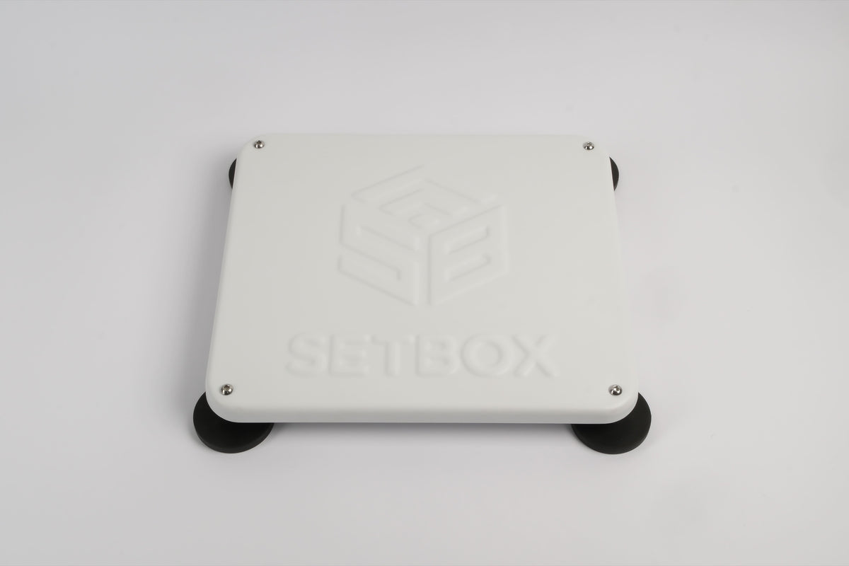SETBOX housing in white, angled view on its magnetic feet