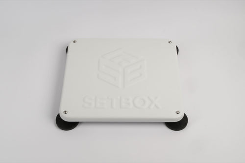 SETBOX housing in white, angled view on its magnetic feet